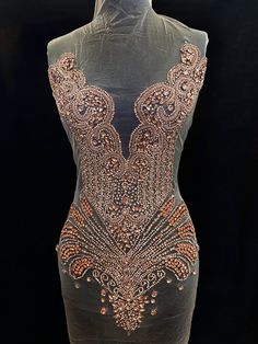 a mannequin is covered in sequins and beading on it's body