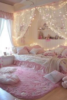 a bedroom decorated in pink and white with fairy lights