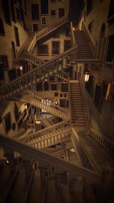 an aerial view of a staircase in a building at night with light from the windows