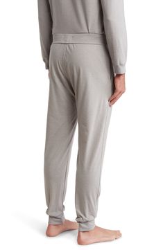 These soft-knit lounge joggers have a relaxed cut that tapers down to snug cuffs which keep the legs from bunching up when you bundle up under a blanket. 29" inseam; 10" leg opening; 12" front rise; 16" back rise (size Medium) Elastic/drawstring waist Side-seam pockets Banded hem cuffs 63% polyester, 34% cotton, 3% spandex Machine wash, tumble dry Imported Men's Clothing A Blanket, Soft Knits, Drawstring Waist, Men's Clothing, Nordstrom Rack, Lounge, Nordstrom, Size Medium, Spandex