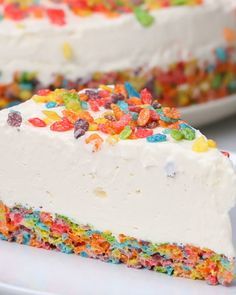 a slice of cake with white frosting and colorful sprinkles