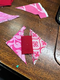 some pieces of fabric are laying on a table