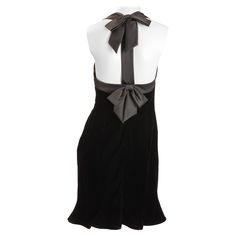 Nipon Boutique black velvet cocktail dress with satin ribbon trim and bows tied at neck and back. Flirty six paneled dress body with flared bottom. Fully lined. Size US 6 Labeled, Nipon Boutique 65% Acetate 35% rayon velvet . Fitted Dress With Bow Tie Back For Black-tie Events, Elegant Knee-length Velvet Dress For Formal Occasions, Chic Dresses With Satin Trim, Elegant Mini Dress With Bow For Black-tie Events, Elegant Knee-length Dress With Bow Tie Back, Silk Party Dress With Satin Trim, Chic Party Dresses With Satin Trim, Chic Evening Dress With Ribbon Detail, Chic Evening Dresses With Ribbon Detail