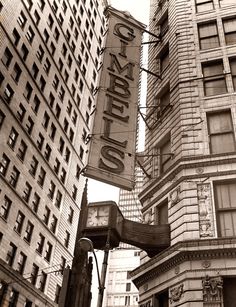 an old photo of a clock on the side of a building