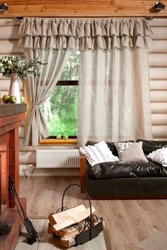 a living room filled with furniture and a fire place in front of a large window