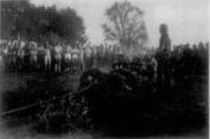 black and white photograph of people standing in front of trees