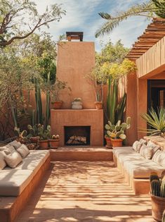 an outdoor living area with couches and cacti