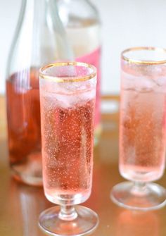 three glasses filled with liquid sitting on top of a table