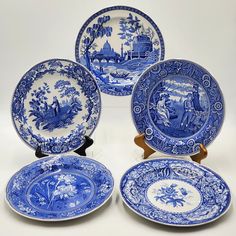 four blue and white plates sitting next to each other