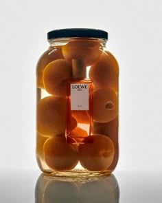 a jar filled with oranges sitting on top of a table