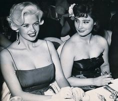 two women sitting next to each other at a table