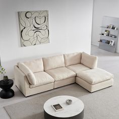 a living room with a sectional couch and coffee table on the floor in front of it