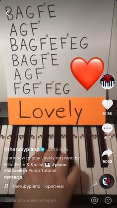 someone is playing the piano with an orange sign that says lovely on it's keyboard