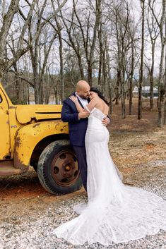 a bride and groom standing in front of a yellow truck