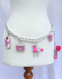 Shocking Pink Rhinestone and Glitter Charm Belli Belt with Sneakers, Pink Kelly Bag, Pink Poodle, Pink Encrusted Heart and Flower. This adjustable chain belt which sits right at the hip is made with big silver curb links  which are interwoven with Baby Pink Suede ribbon. Embellished with dangling Rhinestone and metal charms, including 2 Sneakers, Pink Kelly Bag, Pink Poodle, Pink Encrusted Heart and Flower.Total Charms. (6) The belt is adjustable and closes with a hook depending upon the desired Pink Kelly Bag, Casetify Iphone Case, Pink Kelly, Bling Gifts, Pink Poodle, Sneakers Pink, Shocking Pink, Doll Jewelry, Kawaii Accessories