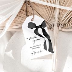 a thank you tag hanging from a palm tree