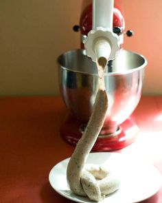 a doughnut on a plate next to a mixer