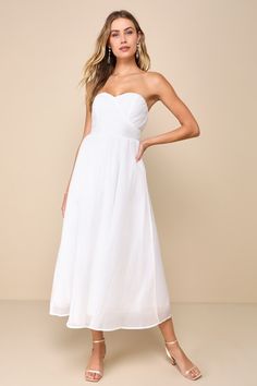 a woman is wearing a white dress