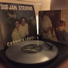 an old record player with two pictures on the cover and one is holding a microphone