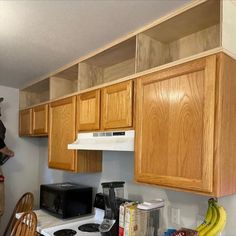 Wooden boxes built above the kitchen cabinets to extend cabinets up to the ceiling.