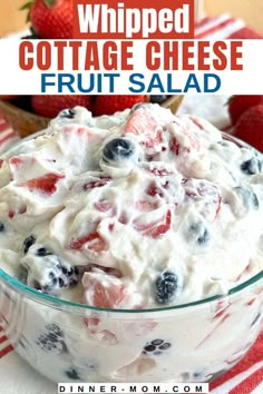 a bowl filled with cottage cheese fruit salad on top of a red and white striped table cloth