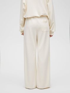 Details: Creamy white trousers Relaxed straight fit Elasticated waistband with drawstring and embroidered logo. Materials & Care: Viscose fibre 48.3 %Polyester fibre 46.7 %Spandex 5.0% Hand wash | Dry clean Do not bleach Size & Fit: Model is 5'7", Bust 32, Waist 24, Hips 35, wearing a size S Item #: IN1PA30 White Straight Leg Loungewear Bottoms, Cream Relaxed Fit Straight Pants, Tailored Cream Straight Pants, White Non-stretch Pants For Streetwear, Cream Relaxed Fit Full-length Pants, White Trousers, Straight Trousers, Sweat Shirt, Trousers