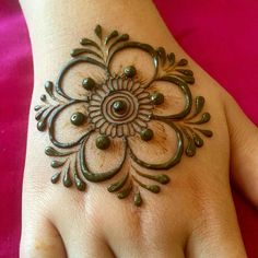 a woman's hand is decorated with hennap and beads on it,