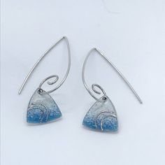 These enamel earrings are made from Sterling Silver with blue and white enamel and fine silver detail. These elegant earrings are stunning for day and also a glamorous look for the evening. The total drop length is approximately: 3cms. ( The enamel units measure approximately: 1.3cms. The scroll hooks are also made from Sterling Silver. If you would prefer standard earring hooks please let me know at Checkout.  Matching necklaces also available. Art Deco Jewellery, Enamel Jewellery, Earrings Triangle, Deco Earrings, Earrings Art, Art Deco Earrings, Triangle Earrings, Deco Jewelry, Enamel Earrings