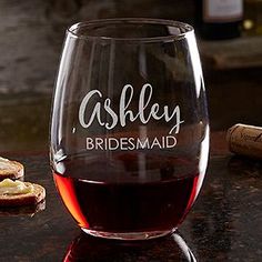 a wine glass sitting on top of a table next to a bottle and corks