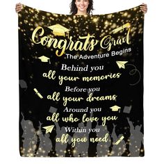 a woman holding up a graduation blanket with the words congrats grad on it