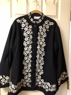 100% Wool Jacket Womens Size Large Black with taupe embroidery flowers around collar, down front and at cuffs. Also a medallion on back. 29” l, 26” pit to pit , 22.5” sleeve, Nehru collar, 100%wool, beautiful striking jacket, 5 buttons, lined. Very good condition, gently worn. Made in India for the Smithsonian Institute. From the 90’s. Embroidery Coats For Women, Fitted Outerwear With Floral Embroidery And Stand Collar, Black Embroidered Winter Outerwear, Long Sleeve Outerwear With Floral Embroidery For Fall, Embroidered Stand Collar Outerwear For Fall, Winter Outerwear With Floral Embroidery And Stand Collar, Traditional Black Outerwear With Floral Embroidery, Embroidered Winter Outerwear With Stand Collar, Casual Outerwear With Floral Embroidery And Stand Collar