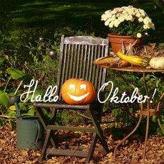 a wooden chair with a pumpkin sitting on top of it next to a potted plant