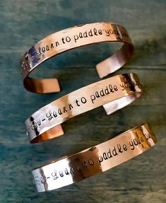 two cuff bracelets that say i can't go to paradise you are going to graduate