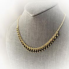 Each black spinel is hand wrapped onto the chain making it especially durable while still providing a delicate appeal. The closely wrapped stones make a beautiful statement of color draping the middle portion of a wearers neckline. This necklace can be worn alone of layered up for many different looks. The base metal is sterling silver with 24k gold vermeil. It is nickel free and hypoallergenic. Dainty Gold Necklace With Black Beads, Yellow Gold Necklace With Black Beads For Gift, Yellow Gold Necklace With Black Beads As Gift, Wrapped Stones, Dainty Chain Necklace, Lapis Necklace, Chain Making, Dainty Chain, Black Spinel