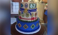 a three tiered cake is decorated with numbers and other things on it's side