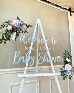 a welcome sign for a baby shower with flowers