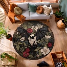 an overhead view of a living room with flowers and a bat rug on the floor