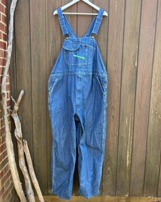 Great pair of Key Imperial overalls, circa 1990s-early 2000s.  Tag size is 50 x 30, unisex 2XL.  There is mild paint staining to the right front leg, shown in photos.  Features zip fly, adjustable bib straps and side pockets.  Waist 24 inches flat across Hips 27 inches flat across Upper thigh 16 inches flat across Inseam 30 inches Total length 68 inches (adjustable) Burgundy Blazer, Levi Jeans 501, Denim Overalls, Early 2000s, Vintage Jacket, Levis Jeans, Bibs, Overalls, Cashmere