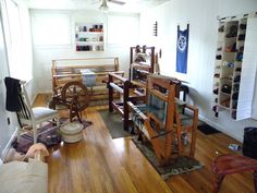 a living room filled with furniture and lots of clutter on top of hard wood floors