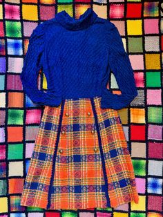 For your consideration is a fantastic 1960's mod a-line dress by "Parade New York". The blouse part of the dress is made of a dark blue nylon textured popcorn knit and has semi-sheer long sleeves. Mock neck. The skirt part is a beautiful woven plaid in dark blue, orange, avocado, yellow, and white. Big gold buttons on the skirt and loopy yarn trim. Chest area of the bodice is lined in acetate. A really cool dress!  Measurements: 36" chest ptp 15" shoulder seam to seam 23" sleeve length  28" waist 40" hip 39" length, shoulder to hem Condition is great. Missing original belt but a gold chain belt would look fab! Please see pics and ask any questions prior to purchasing as all sales are final. Price includes shipping! Thanks for looking! Loopy Yarn, Gold Chain Belt, 1960s Mod, Chain Belt, Dress Measurements, Gold Buttons, Dress Clothes For Women, Blue Orange, Gold Chain