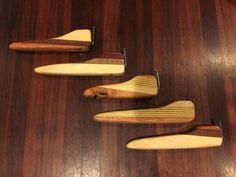 four wooden paddles are lined up on a table