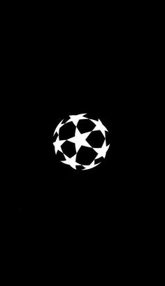 a black and white photo with a soccer ball on it's back side in the dark