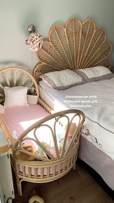 a small child's bed in a room with a wicker headboard and foot board