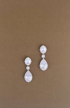 Our Stunning AWE Drop Earrings with Swarovski Crystals are Absolutely Gorgeous. The design includes a combination of big Swarovski crystals and cubic zirconia crystals. The pair of earrings are the perfect touch to any look to give it a fancy and gorgeous touch.  The earrings can be styled with most of our wedding headpieces, Bridal Tiaras and Crowns ♦ Check us on IG for more photos, Videos and Styles @ElleeCoutureBoutique ♦ Handcrafted Unique Design ♦ Highest Quality & Finest Materials ♦ Brilli Wedding Drop Earrings, Crystal Wedding Earrings, Wedding September, Crystal Wedding Necklace, Inspo Pictures, Bridal Tiaras, Wedding Headpieces, Crystals Earrings, Crystal Wedding Jewelry