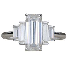 an emerald cut diamond ring with three baguets