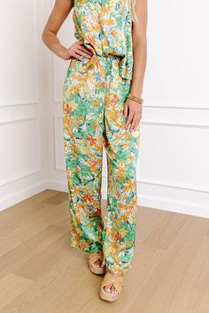 - You will be living the luxe life in these beautiful pants! - Lightweight, unlined material with a colorful floral pattern and a satin finish - A high elastic waistline - A relaxed silhouette that ends in a straight floor length hemlines Measurements S : Front Rise 13", Hip 34", Inseam 30", Length 39.5", Waist 23-25". M : Front Rise 13.5", Hip 36", Inseam 30", Length 40", Waist 25-27". L : Front Rise 13.5", Hip 38", Inseam 30.5", Length 40.5", Waist 27-29". Spring Tropical Print Pants, Green Lounge Pants For Spring, Multicolor Tropical Print Pants For Spring, Multicolor Tropical Print Spring Pants, Green Floral Print Vacation Pants, Green Floral Print Ankle Pants, Green Floral Print Ankle-length Pants, Casual Green Floral Print Pants, Green Ankle-length Pants With Floral Print