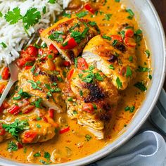 chicken enchilada with rice and cilantro in a white bowl on a table