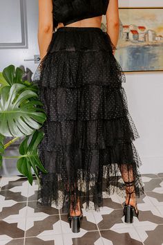 - This trendy tulle skirt in a showstopper! - Airy tulle material with a polka-dot design and a built in lining - A stretchy elastic waistline - A Flowy tiered silhouette that ends in a high-low hemline with the front ending mid-thigh Chic Black Mesh Skirt, Chic Tulle Mesh Skirt, Chic Tulle Skirt With Mesh Material, Chic Mesh Tulle Skirt, Spring Mesh Skirt For Night Out, Spring Night Out Mesh Skirt, Spring Party Mesh Skirt, Chic Mesh Bottoms With Tulle Skirt, Black Tulle Bottoms With Pleated Skirt