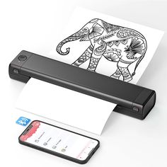 an elephant is drawn on a sheet of paper next to a cell phone and printer