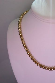 Gold Bead Choker Necklace Single Strand Gold Metal 7 mm Lightweight Beads Classic 1970's Choker Necklace Signed Korea on tag Spring ring closure Lightweight, wt. 1.5 oz. Vintage from the 1970's Size: 18 inches Condition: Very good, no damage noted. More Gold necklaces: http://etsy.me/1FVd6Br Bead Choker Necklace, 1928 Jewelry, Bead Choker, Grand Rapids Mi, Gold Necklaces, Beaded Choker Necklace, Pearl Choker, Beaded Choker, Chain Ring